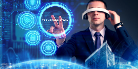 Business, Technology, Internet and network concept. Young businessman working on a virtual screen of the future and sees the inscription: Transformation
