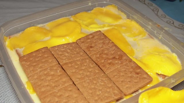 Making delicious Mango Graham cake for desert - close up