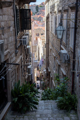 Fototapeta premium Narrow and steep street in Dubrovnik, formerly Ragusa, city located on the Dalmatian coast, Croatia, Europe