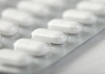 Fototapeta na wymiar Pills capsule in plastic strip on white background. Antibiotics, vitamins, painkiller.