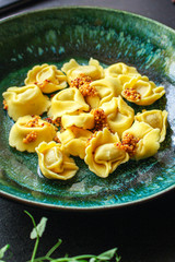 tortellini, pasta with filling (ravioli or dumplings) second course Menu concept. food background. top view copy space for text