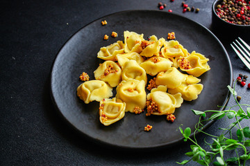 tortellini, pasta with filling (ravioli or dumplings) second course Menu concept. food background. top view copy space for text