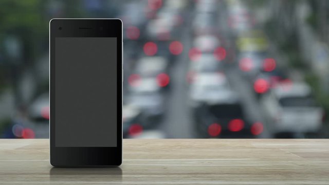 Law flat icon on modern smart mobile phone screen on wooden table over blur of rush hour with cars and road in city, Business legal service online concept