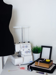seamstress workplace with sewing machine, mannequin, cutting fabrics and details