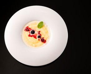 dessert plate with custard on white plate
