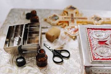 Church items. Items for the rite of christening a child. Cross, holy water, icons, miro, oil anointing.