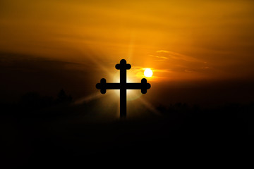 Glow of the Lord. Holy place. The concept of Jesus Christ: the cross at sunset.