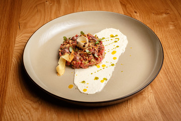 Raw beef meat tartar with mashed potatoes on a side.