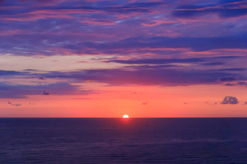 The sun sets over the horizon over the Black Sea in Batumi, Adjaria, Georgia. Relaxation and meditation, the concept of peace and silence. Design for postcard or calendar, place for text.