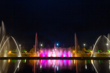 Fototapeta na wymiar A famous attraction in Batumi is the bright singing and dancing fountains on the promenade. Night photo, selective focus. Adjara Autonomous Republic, Georgia, Eurasia. Festive mood.