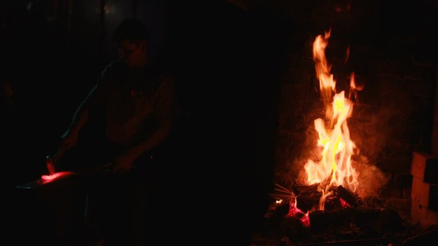 A blacksmith forging horseshoes for horses