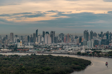 Beautiful view of Bangkok city, Beauty skyscrapers along Chaopraya river in the evening, making the city modern style.