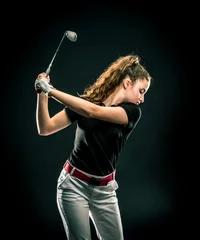 Foto op Plexiglas Girl looking for the perfect golf shot isolated on black background  © trattieritratti