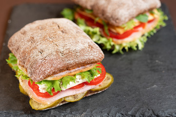 Several sandwiches with meat and vegetables. Photo of sandwiches with shallow depth of field. Top angle view.