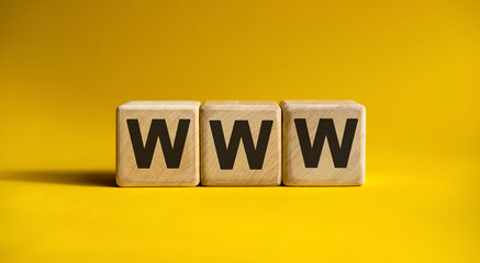 WWW website - text on wooden cubes with gradient yellow background