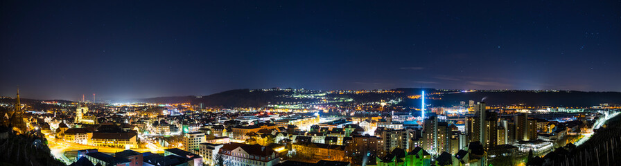 Germany, XXL panorama of starry night sky over modern buildings of swabian medieval city esslingen...