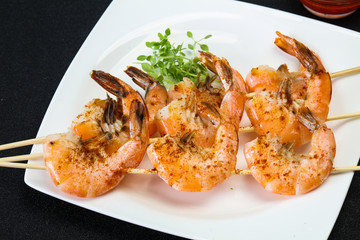 Grilled prawn skewer with sauce