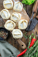 Dumplings with minced meat. Hand imposing forcemeat.