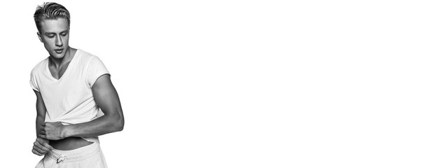 Sexy shirtless male model flirting against white background