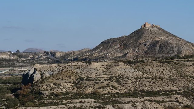 View across desert with the Arabic Fortress Nazari castle on hilltop, Tabernas, Almeria province, Andalusia, Spain