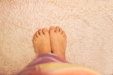 woman feet top view on bath mat - Barefoot on the mat- Two feet standing- Pink carpet