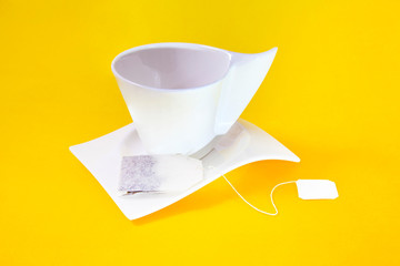 shaking green tea in a white cup against yellow background