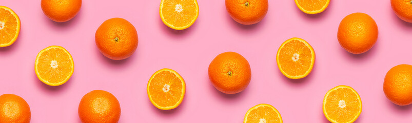 Fruit pattern, creative summer concept. Fresh juicy whole and sliced orange on pink background. Flat lay Top view. Minimalistic background with citrus fruits, vitamin C. Pop art design Banner