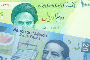 A green ten thousand rial bank note from Iran with a blue, Mexican twenty peso shot close up in macro