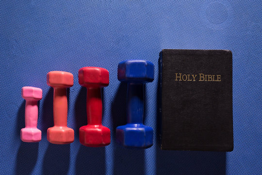 Colorful Gym Weights and Holy Bible