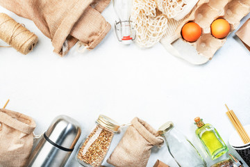 Zero waste, plastic free and sustainable lifestyle concept. Recyclable, reusable eco friendly bags, package, bottles, cans and storage containers, mesh bag. White background, copy space, top view