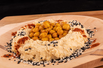 Fried or oven roasted chickpeas and hummus paste spiced turmeric curcuma