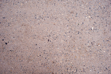 Texture of a concrete wall with stone chips. Part of the structure.