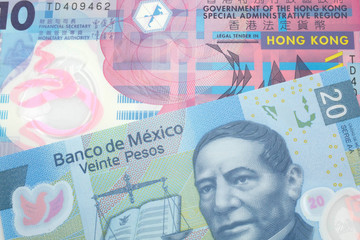 A colorful ten dollar bill from Hong Kong shot in macro with a blue, Mexican twenty peso bill