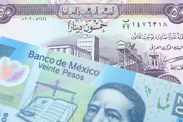 A purple fifty dinar note from Iraq close up with a twenty peso note from Mexico