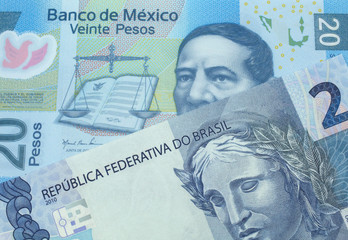 A twenty Mexican peso bank note with a blue two Brazilian reais bill. Shot in macro.
