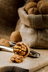 cracked walnut with nutcracker on cutting board