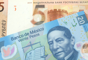 A close up image of a twenty peso note from Mexico with a one hundred ruble note from Belarus