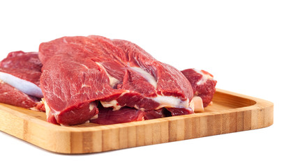 Raw meat on wooden board isolated on white background