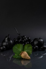Black fruits on gray background