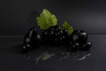 Black fruits on gray background