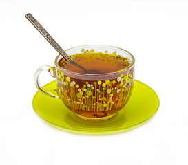 Decorated cup with tea and a spoon on a green saucer