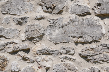 Stone wall, large gray stones, civil and industrial construction.