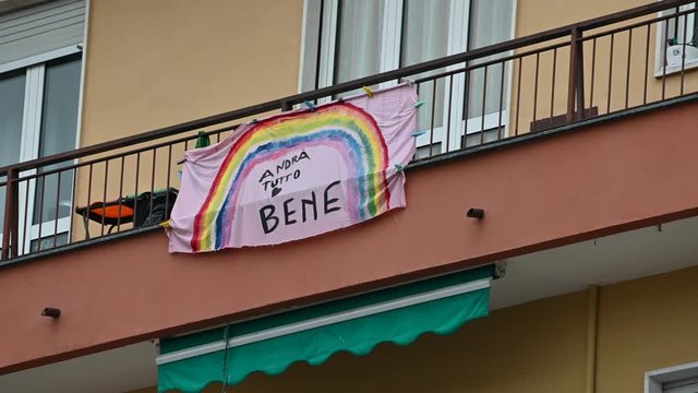 Turin, Piedmont, Italy. May 2020. Coronavirus pandemic. On the facades of the houses hang the sheets with the drawing of the rainbow and message everything will be fine. In Italian "Andr&agrave; tutto bene"