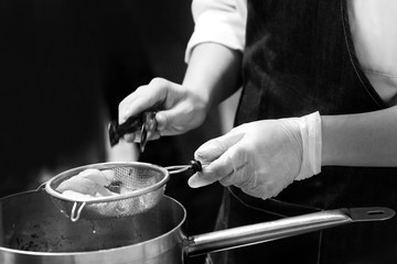 Chef cooking in a kitchen, chef at work, Black & White.