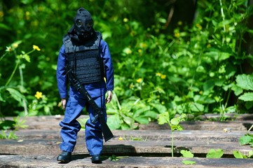 A toy soldier with a gas mask and a gun. Object on a green background.