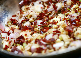 Roasted garlic and dried red pepper seasoning in pan Chili Garlic Oil