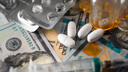 Medicine and money. White pills and a hundred dollars. Financing the production of medicines against coronavirus Covid-19 (SARS-CoV-2), viral and bacterial infections in laboratories. Template. 