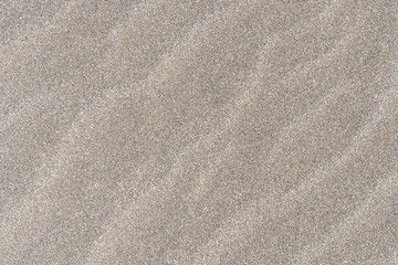 Closeup of sand pattern of a beach in the sunny day