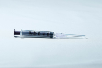 Single use syringe on white background