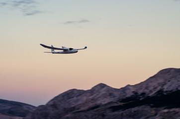 Fototapeta na wymiar plane flying over mountain at night